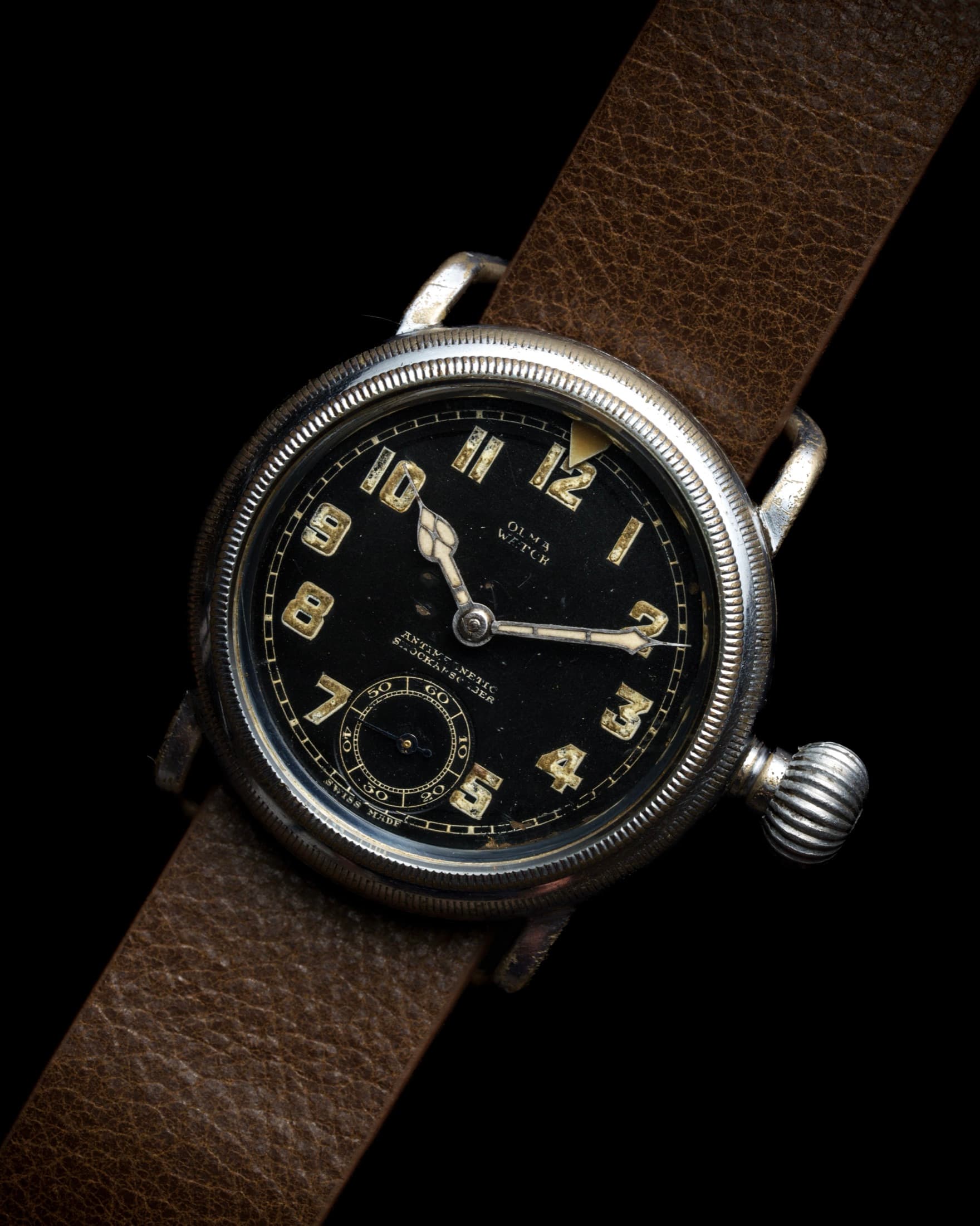 Vintage military pilot's watch with black dial and luminous numerals on a leather strap